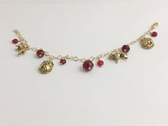 14k gold filled bracelet with goldtone pewter charms and red accent beads